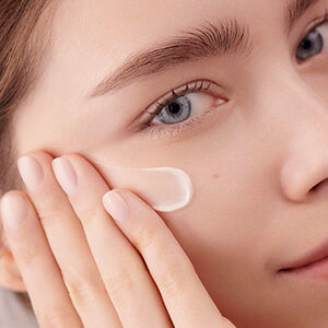 Advanced Genifique Serum und Renergie Multi Lift Creme liegen auf einem Tablett auf dem Tisch