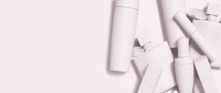 Eine Anordnung von weißen Kosmetikverpackungen auf einem hellen Hintergrund.