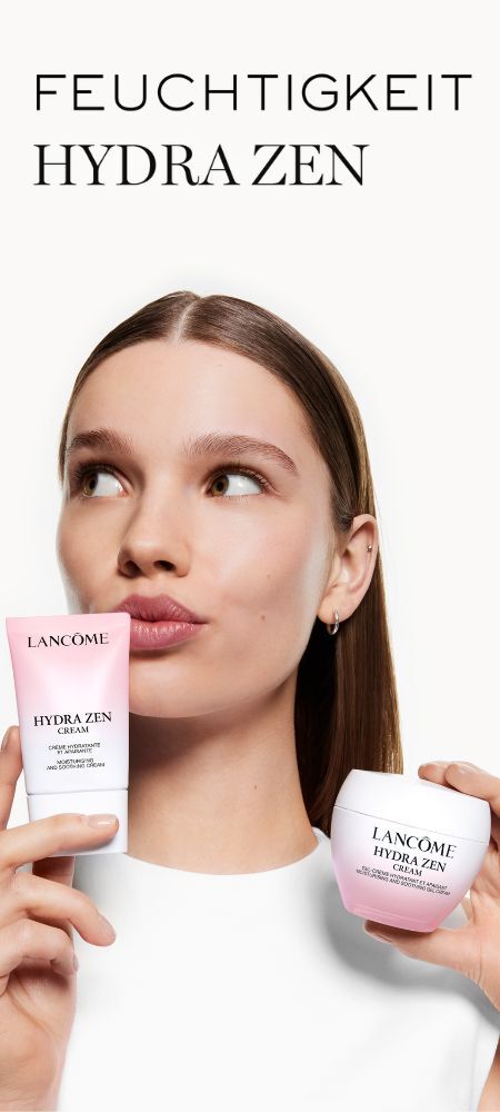 Eine Frau halt eine Tube und einen Tiegel der Lancome Hydra Zen Creme, blickt mit gespitzten Lippen nach rechts. Der Text „FEUCHTIGKEIT HYDRA ZEN“ steht oben.