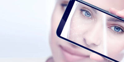 Nahaufnahme einer Frau, die eine digitale Hautanalyse auf dem Smartphone durchfuhrt